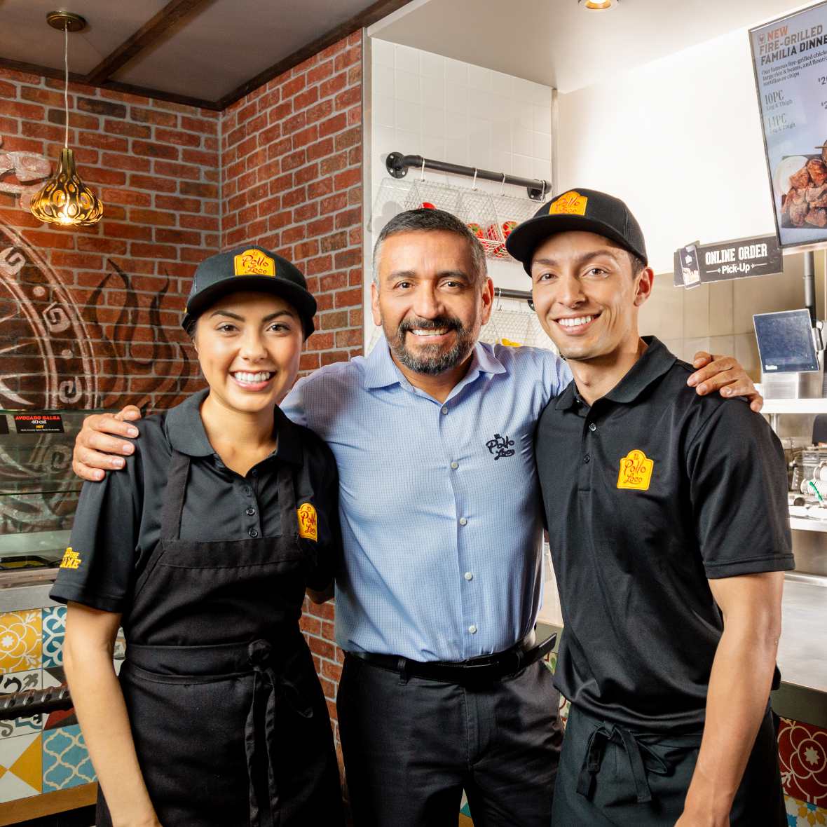 Franchise owner standing with some of their employees.