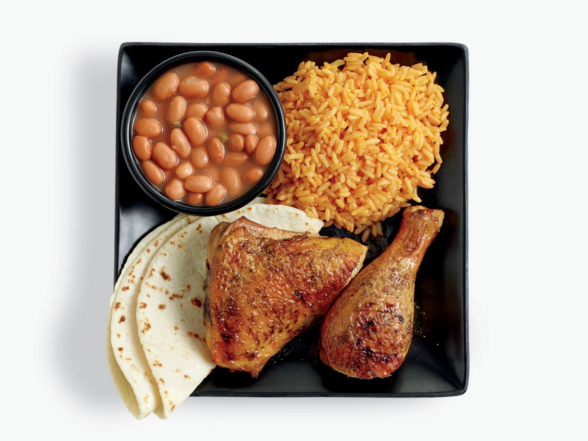 Two pieces of chicken with side of beans, rice, tortillas, and pico de gallo