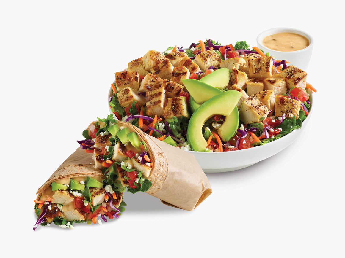 Citrus Avocado Fresca Salad in a white bowl with a side of citrus vinaigrette dressing.