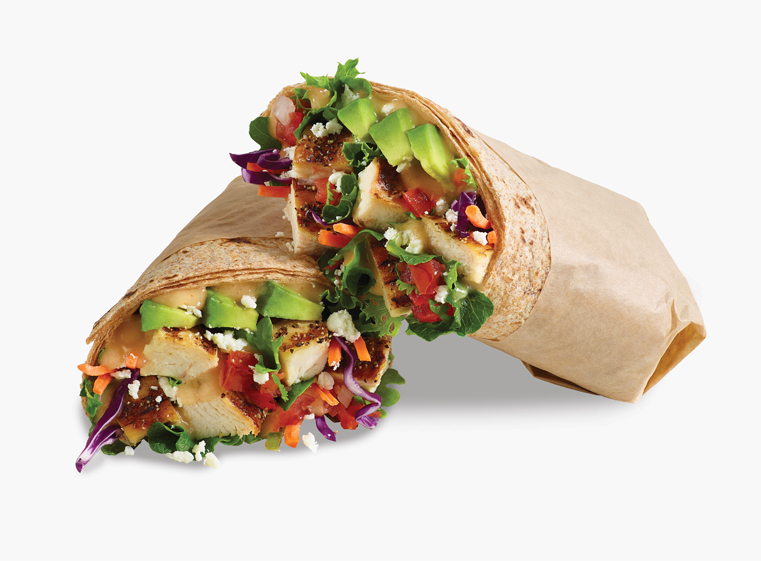 Citrus Avocado Fresca Wrap cut in half leaning against each other in tan paper.
