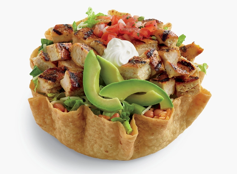 Double Chicken Tostada Salad in tostada shell topped with avocado