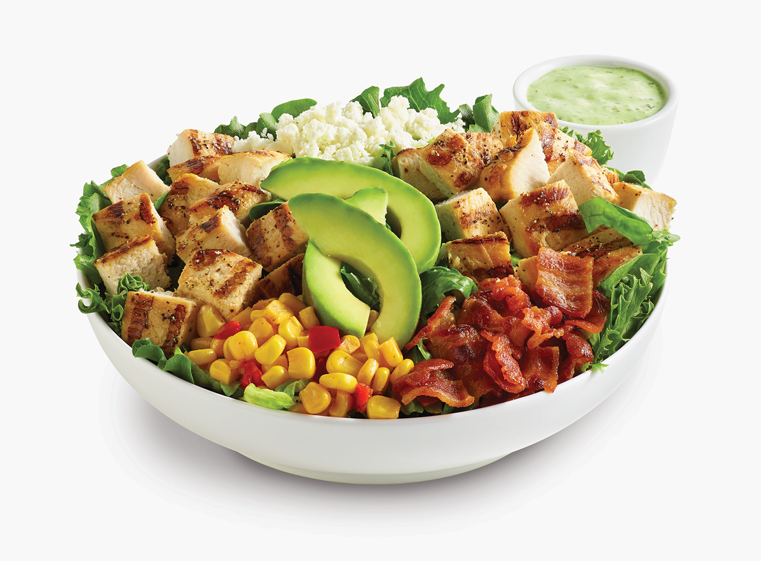 Mexican Cobb Fresca Salad in a white bowl with a side of creamy cilantro dressing.