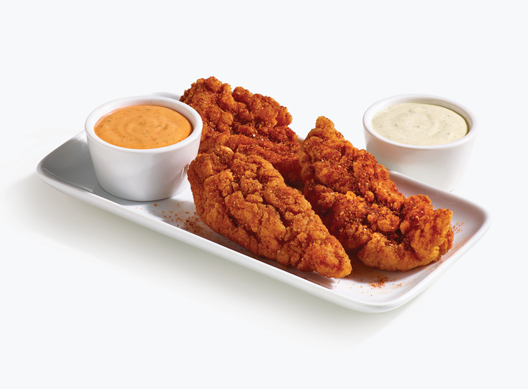 3 piece spicy tenders on a white plate with loco sauce and baja lime sauce in white ramekins