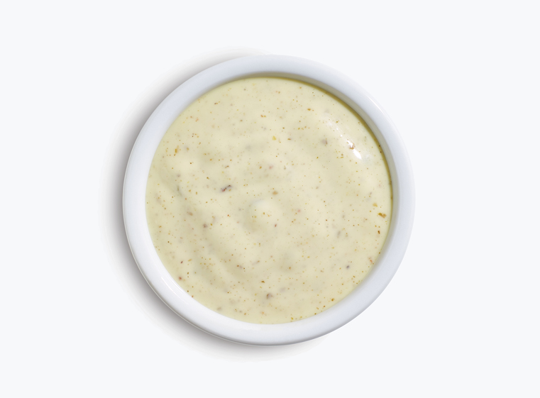 lime crema sauce in a white cup