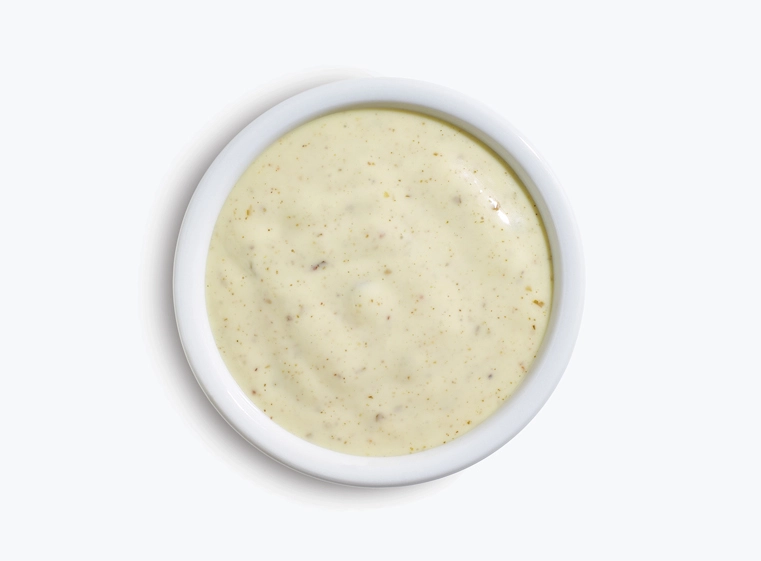 lime crema sauce in a white cup
