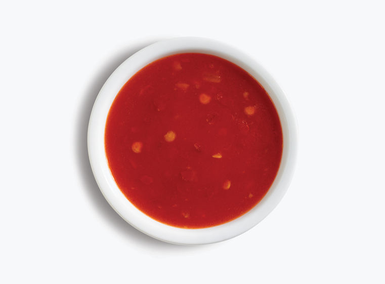 a cup of mango habanero sauce in a white ramekin