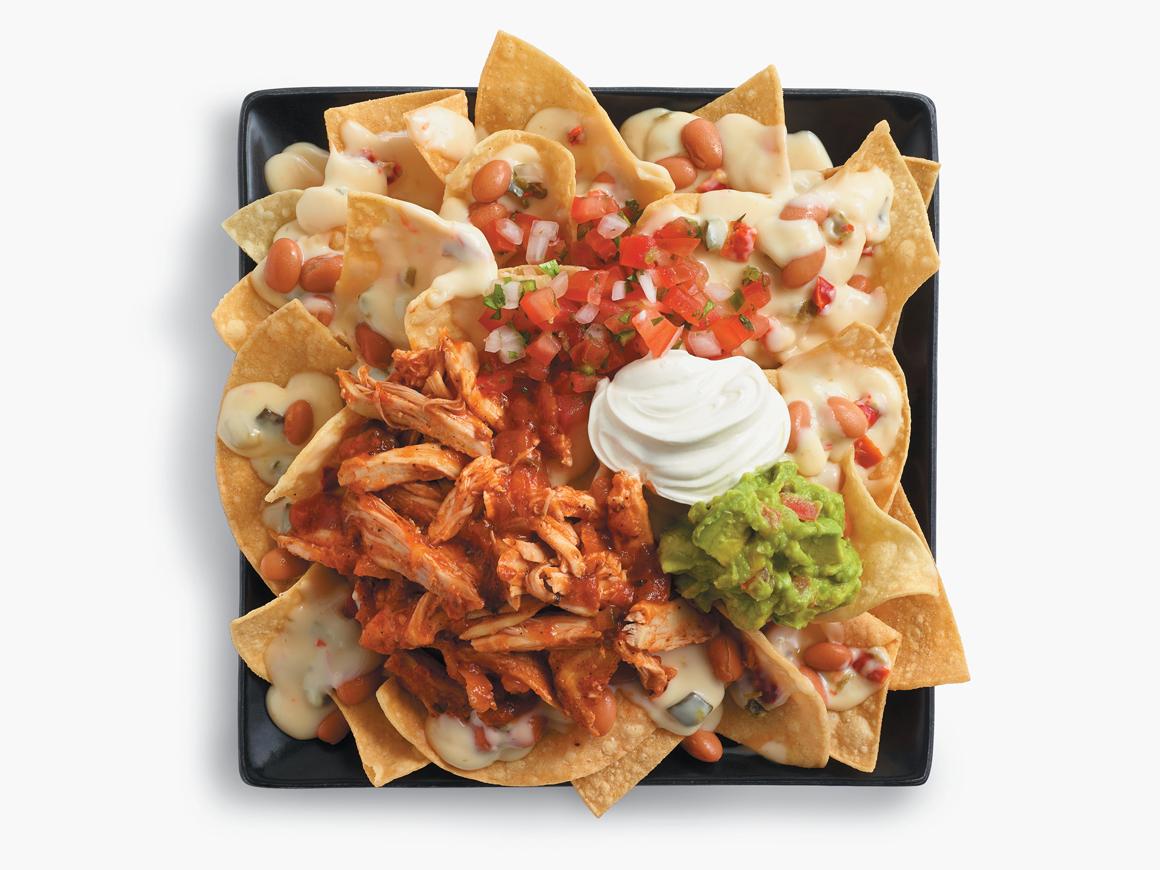 Shredded Chicken Nachos on a Black Plate