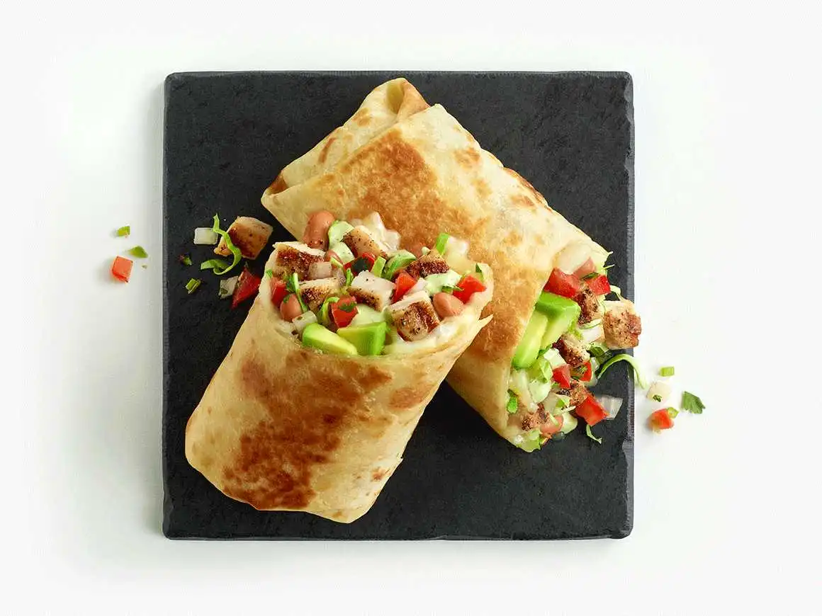 Grilled Chicken Avocado Burrito cut in half showing ingredients